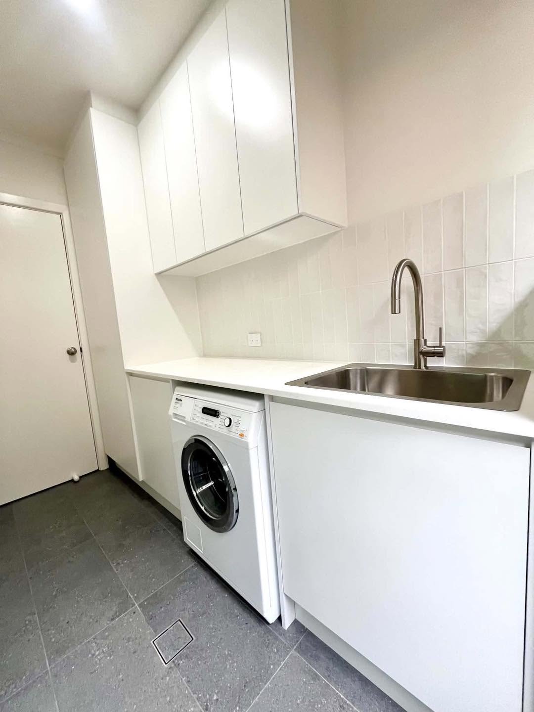 White Laundry with Upper Cabinets